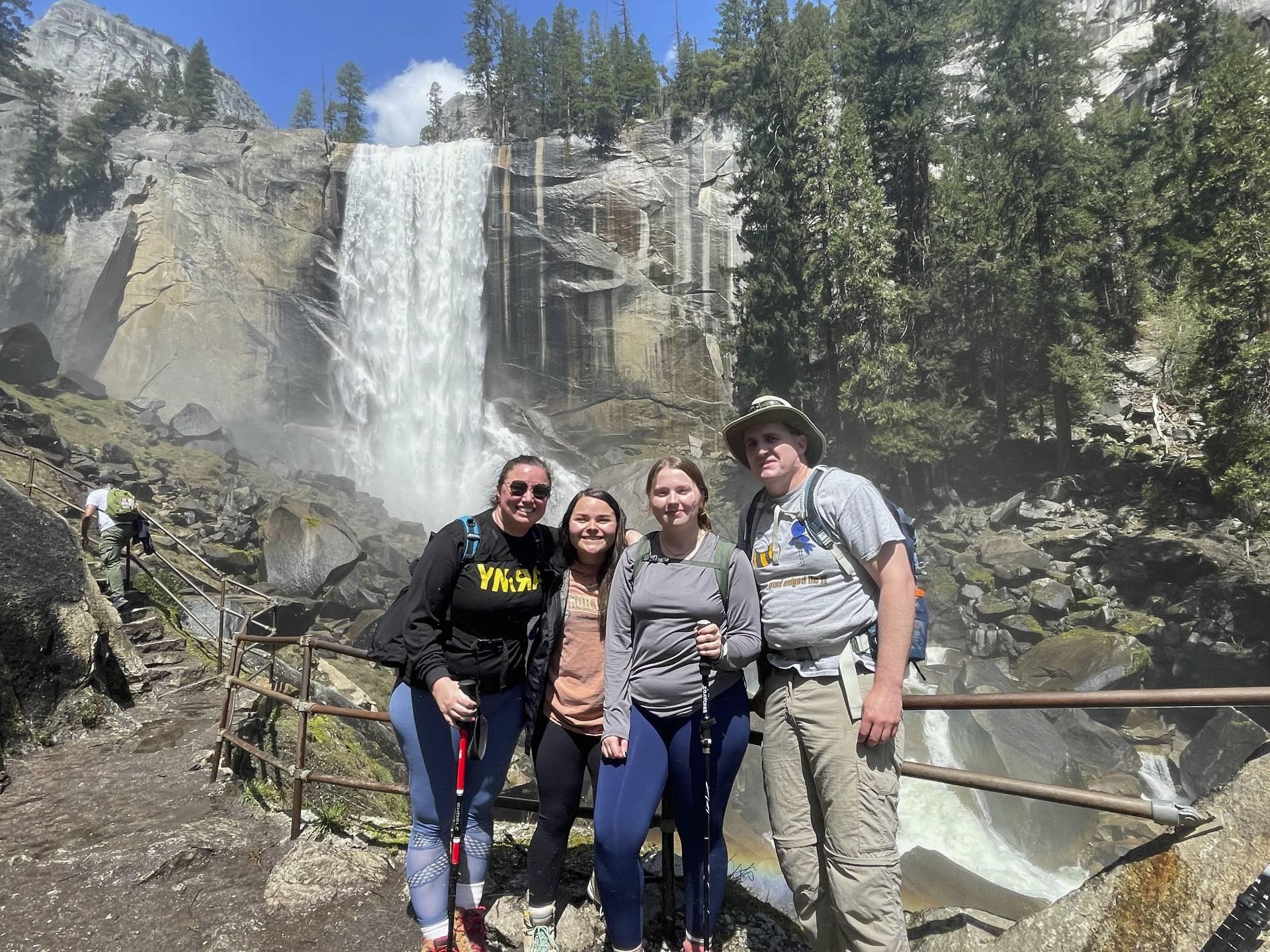 The Biology Club posing for a photo in front of a waterfall